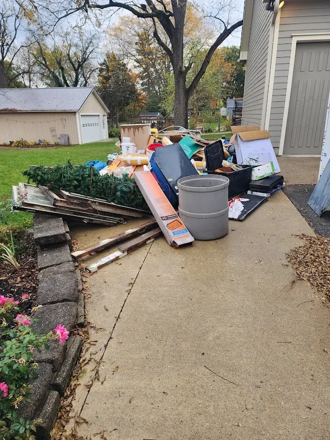 Dumpster being loaded with debris for Estate Cleanout Dumpster Rental in Lima